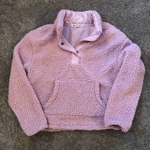 Pink thick fuzzy pullover.